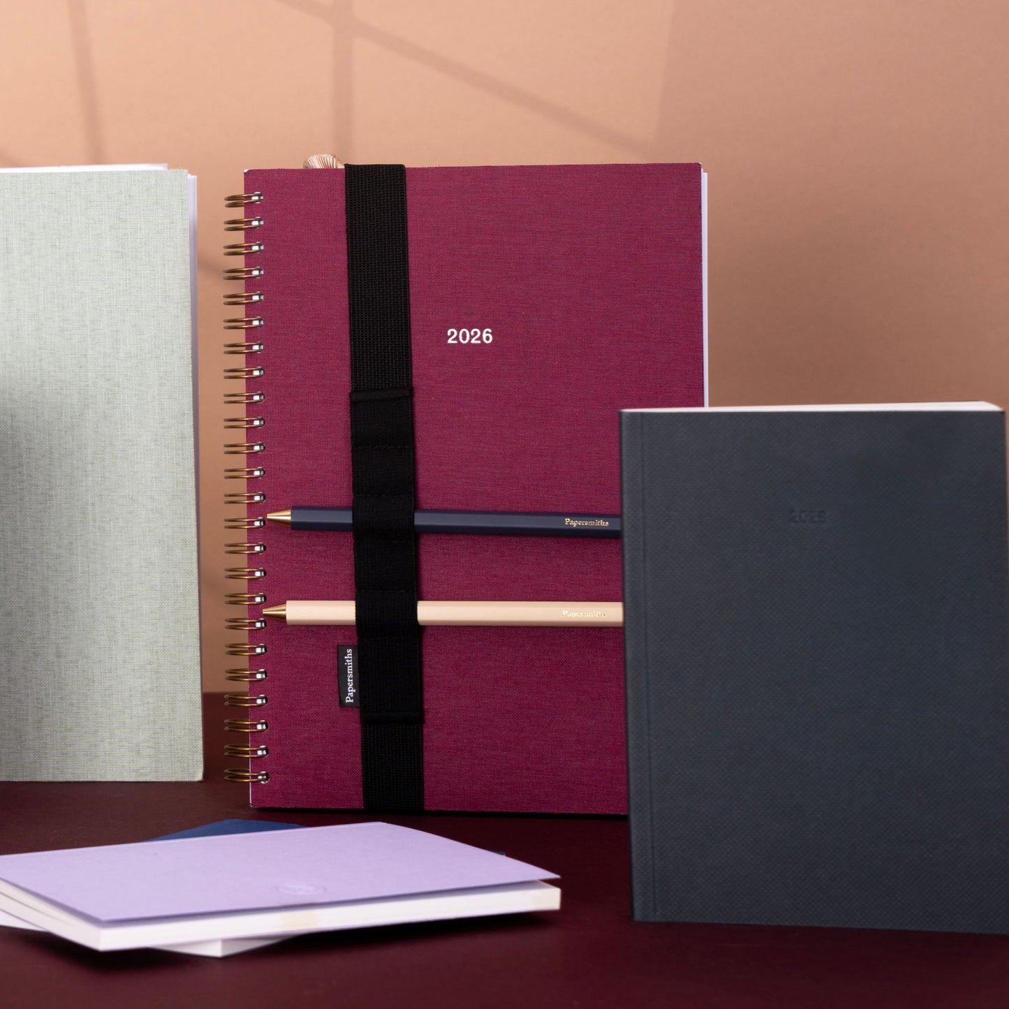 Set of notebooks including a maroon one with '2026'