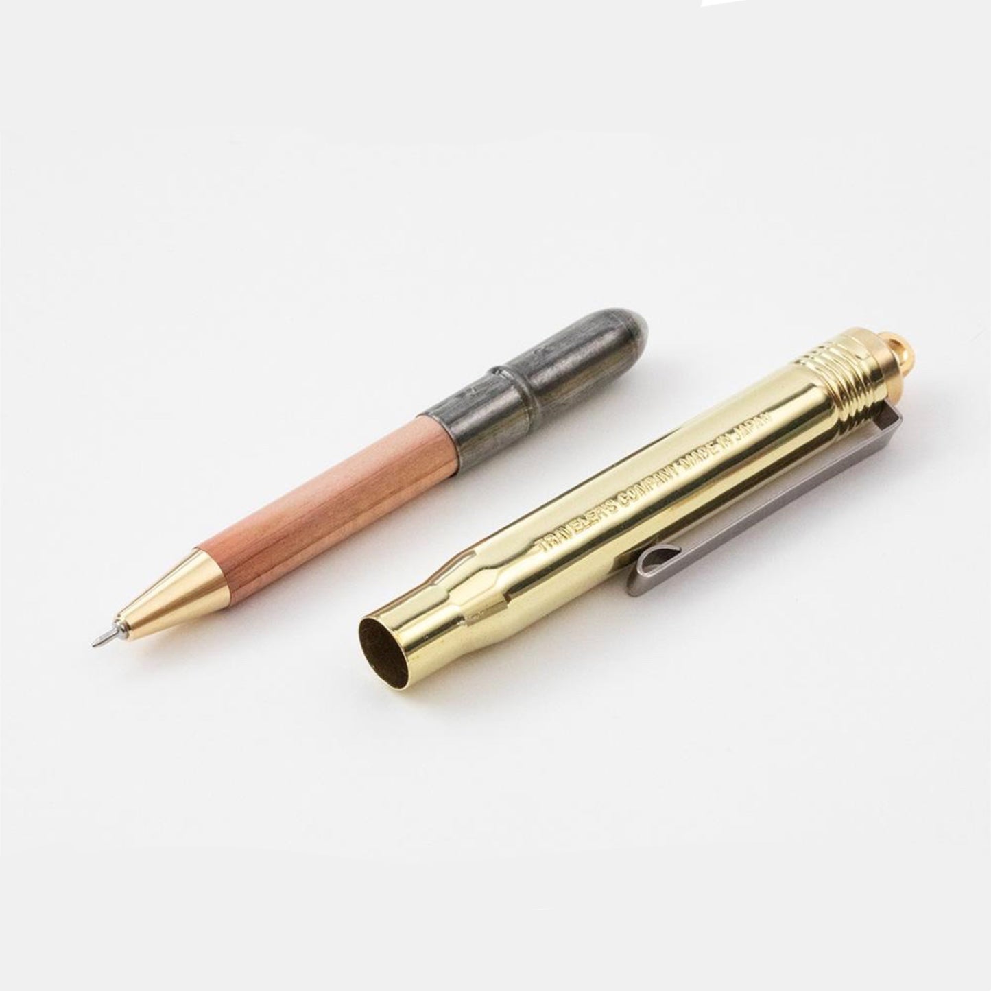 brass ball point pen and lid